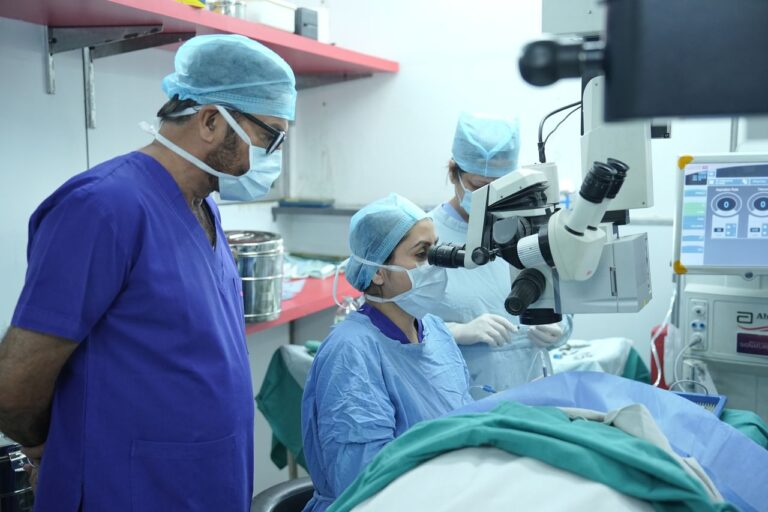 Surgeons performing eye surgery in a New Delhi hospital operating room.