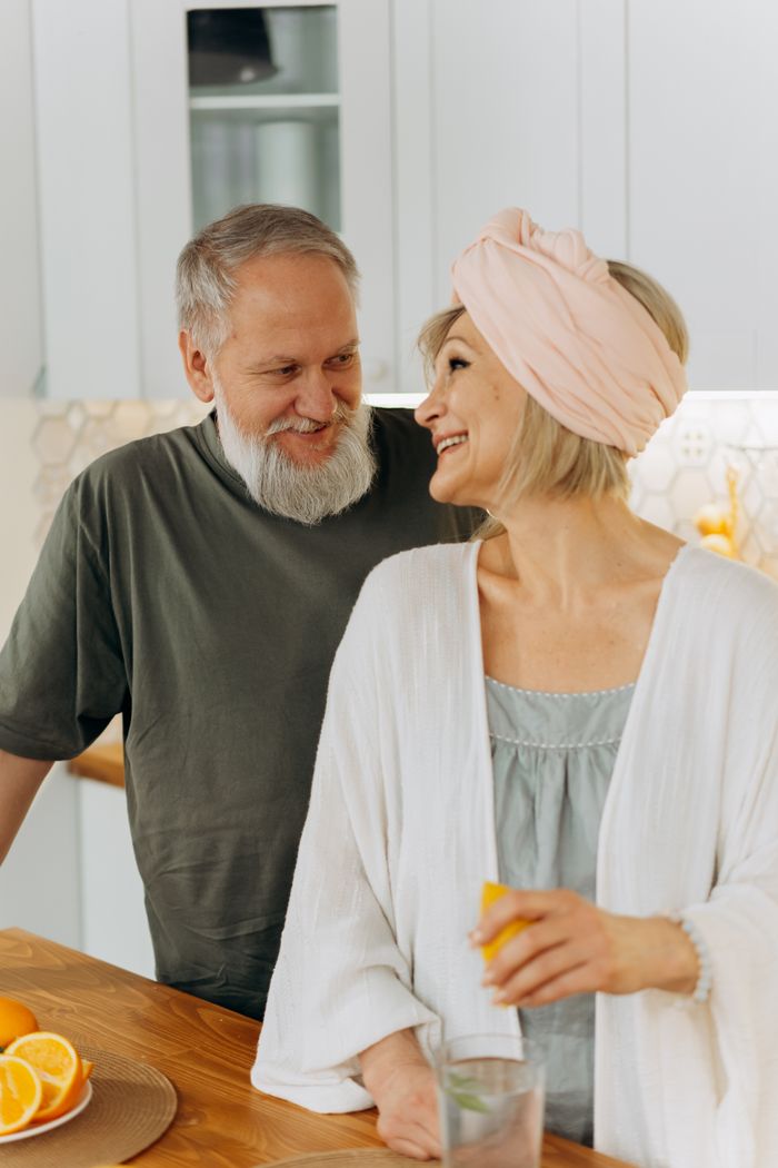 Joyful senior couple sharing a moment in the kitchen, enhancing time together.