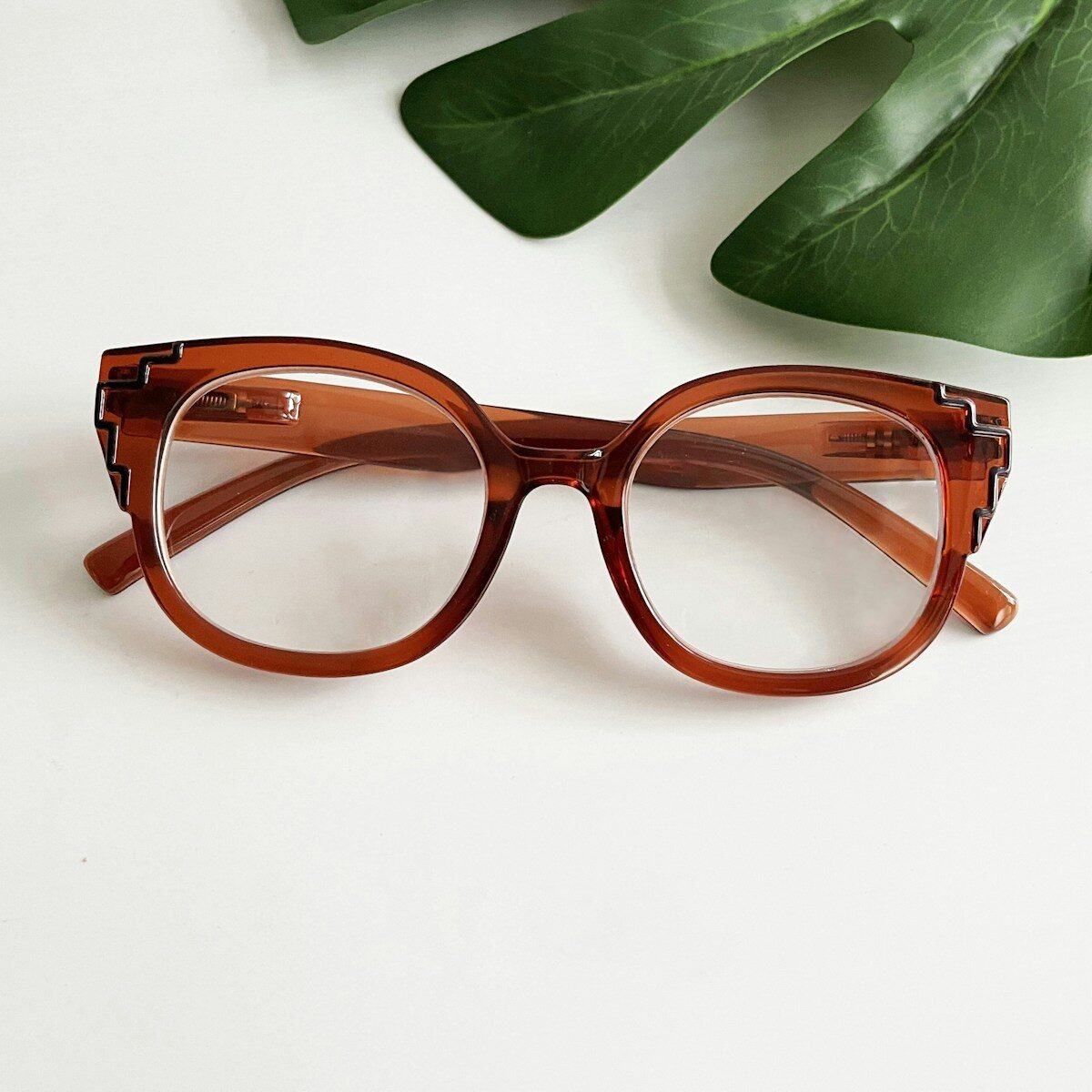 a pair of glasses sitting on top of a table